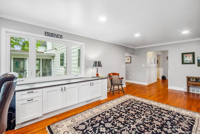 interior space featuring light wood-type flooring, ornamental molding, baseboards, and recessed lighting