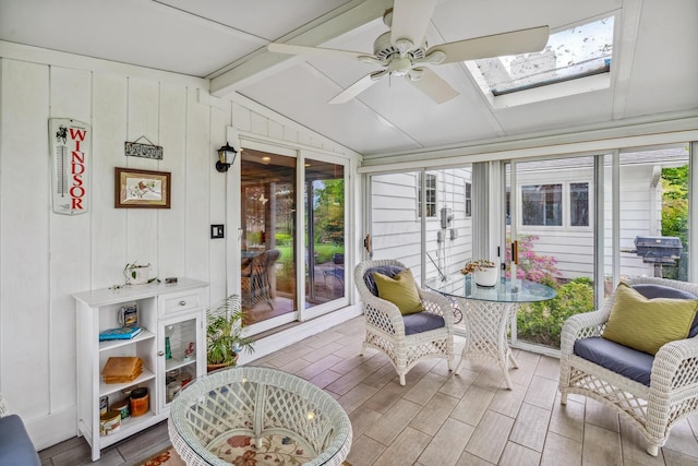 sunroom with plenty of natural light, a ceiling fan, and a skylight