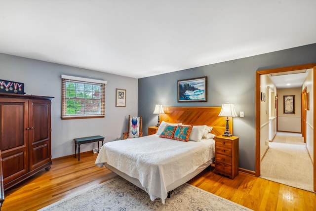 bedroom featuring wood finished floors and baseboards
