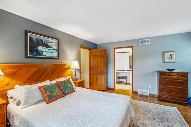 bedroom with wood finished floors and baseboards