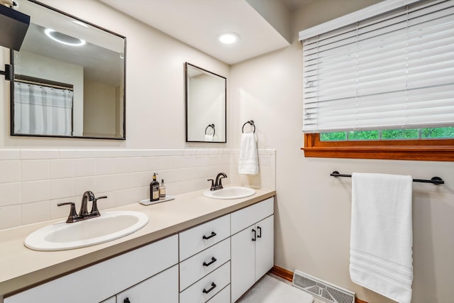 full bathroom with backsplash, double vanity, baseboards, and recessed lighting