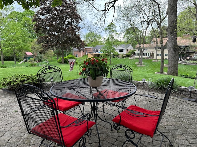 view of patio / terrace featuring outdoor dining area and a playground