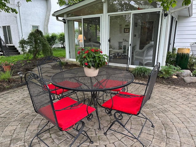 view of patio featuring outdoor dining area and entry steps