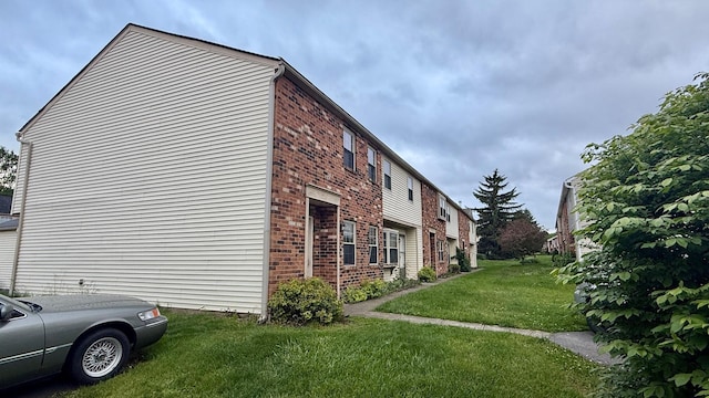 1721 Worthington Run Dr Unit 1721-1731, Columbus, OH 43235 - view of property exterior featuring brick siding and a lawn