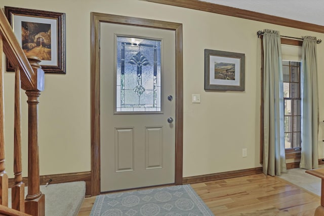 7689 Godfrey Cir, Reynoldsburg, OH 43068 - foyer entrance with stairs, light wood-type flooring, and ornamental molding