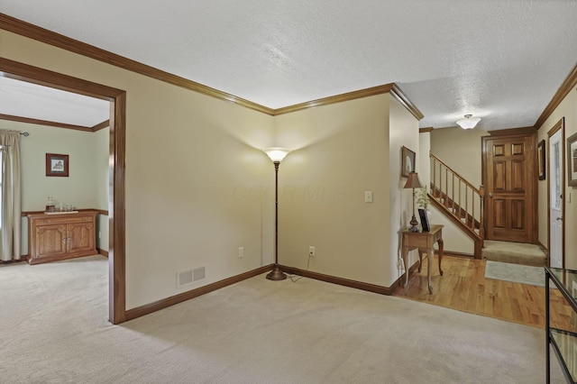 7689 Godfrey Cir, Reynoldsburg, OH 43068 - spare room featuring crown molding, light carpet, stairs, and a textured ceiling