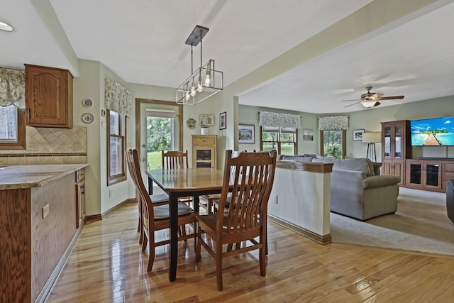 7689 Godfrey Cir, Reynoldsburg, OH 43068 - dining room with light wood finished floors, a ceiling fan, and a chandelier