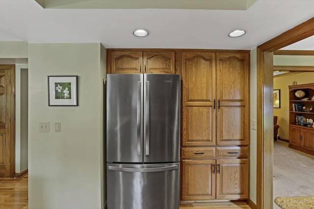 7689 Godfrey Cir, Reynoldsburg, OH 43068 - kitchen featuring freestanding refrigerator, brown cabinetry, light carpet, and recessed lighting