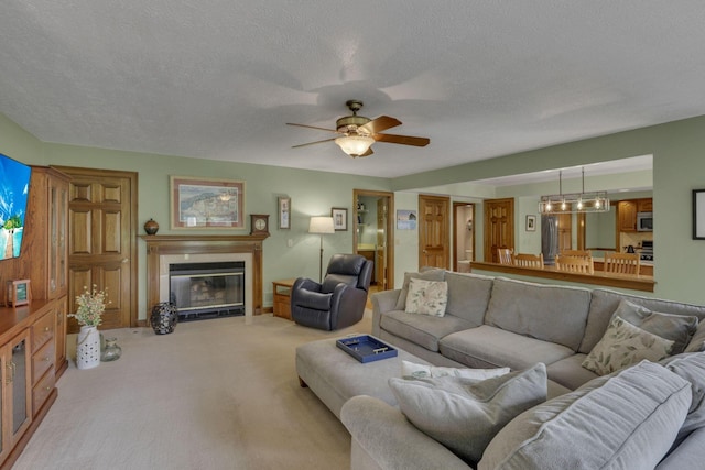 7689 Godfrey Cir, Reynoldsburg, OH 43068 - living room featuring a tiled fireplace, carpet flooring, ceiling fan, and a textured ceiling