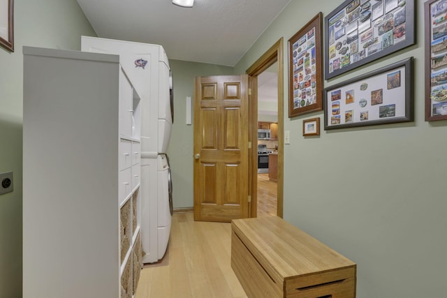 7689 Godfrey Cir, Reynoldsburg, OH 43068 - laundry room featuring stacked washing machine and dryer and light wood finished floors