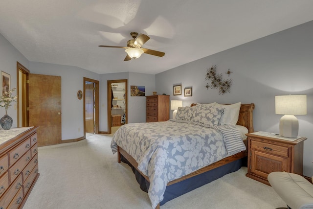 7689 Godfrey Cir, Reynoldsburg, OH 43068 - bedroom featuring light colored carpet, a walk in closet, a closet, a ceiling fan, and connected bathroom