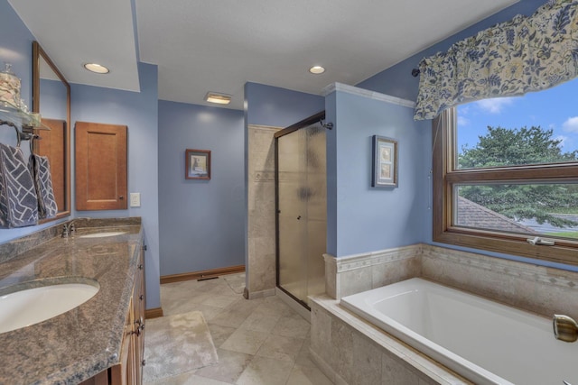 7689 Godfrey Cir, Reynoldsburg, OH 43068 - bathroom featuring a stall shower, a bath, double vanity, and recessed lighting