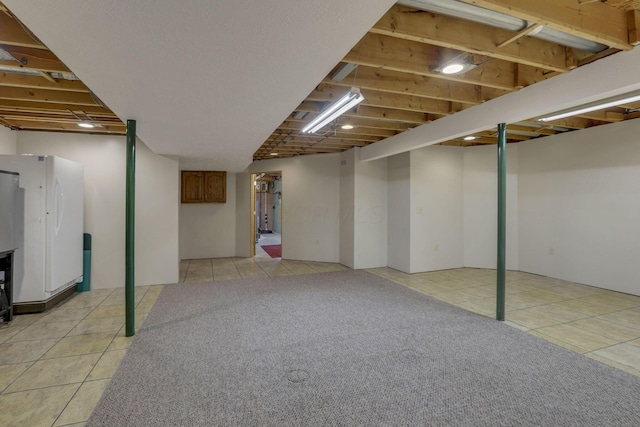 7689 Godfrey Cir, Reynoldsburg, OH 43068 - finished below grade area with freestanding refrigerator and light tile patterned floors