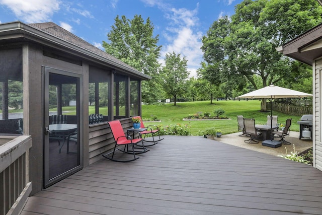 7689 Godfrey Cir, Reynoldsburg, OH 43068 - wooden terrace with outdoor dining area, a lawn, and a sunroom