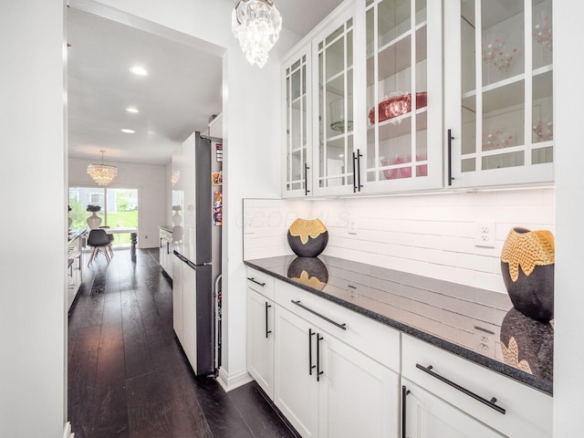 757 Avebury Dr, Pickerington, OH 43147 - bar with a chandelier, freestanding refrigerator, backsplash, dark wood-type flooring, and pendant lighting