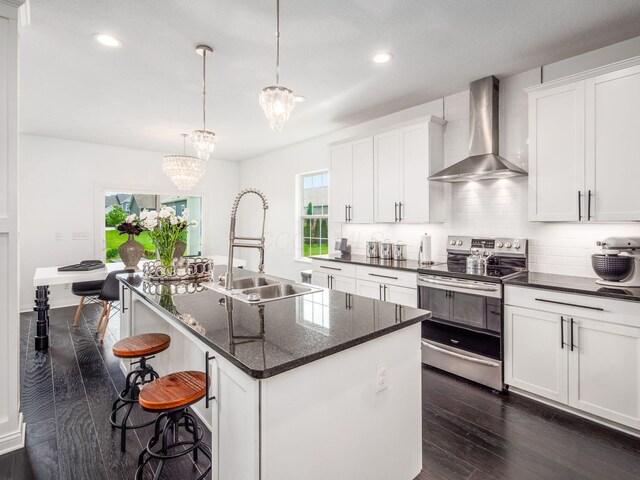 757 Avebury Dr, Pickerington, OH 43147 - kitchen featuring electric stove, wall chimney range hood, a sink, dark wood finished floors, and decorative backsplash