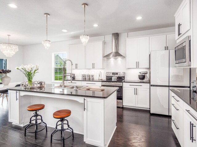 757 Avebury Dr, Pickerington, OH 43147 - kitchen with stainless steel appliances, a sink, wall chimney range hood, dark wood-type flooring, and recessed lighting