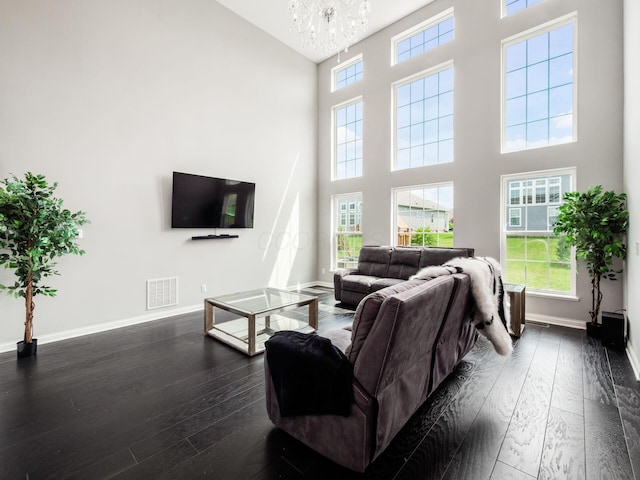 757 Avebury Dr, Pickerington, OH 43147 - living room with a towering ceiling, dark wood finished floors, a chandelier, and baseboards