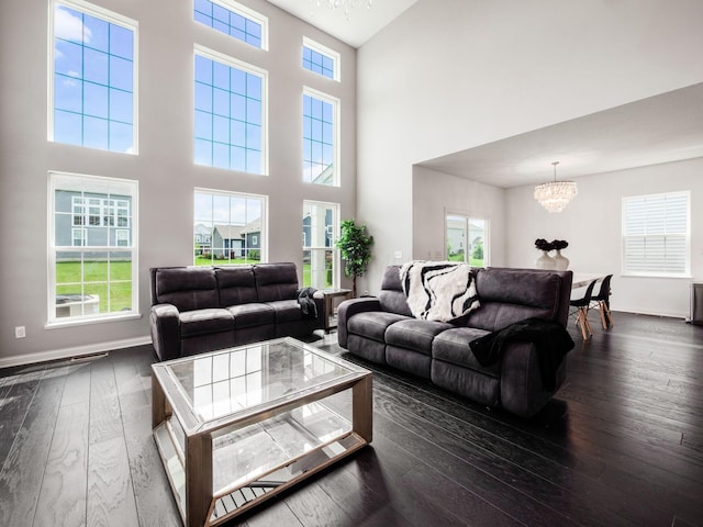 757 Avebury Dr, Pickerington, OH 43147 - living area featuring a chandelier, a towering ceiling, healthy amount of natural light, dark wood-style floors, and baseboards