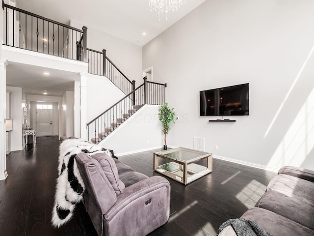 757 Avebury Dr, Pickerington, OH 43147 - living room featuring wood-type flooring, a high ceiling, baseboards, stairs, and a chandelier
