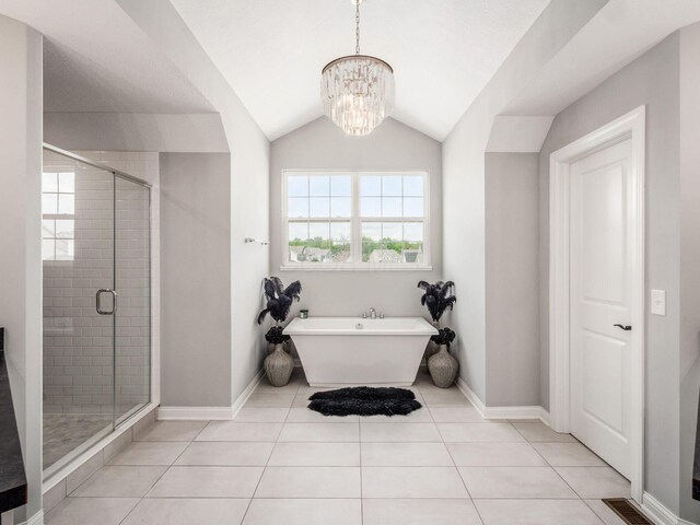 757 Avebury Dr, Pickerington, OH 43147 - full bathroom with a shower stall, baseboards, lofted ceiling, a chandelier, and a freestanding tub