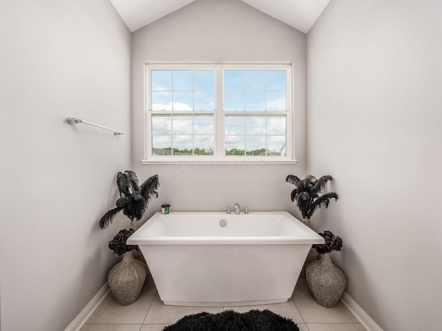 757 Avebury Dr, Pickerington, OH 43147 - bathroom featuring baseboards, tile patterned flooring, a freestanding bath, and vaulted ceiling