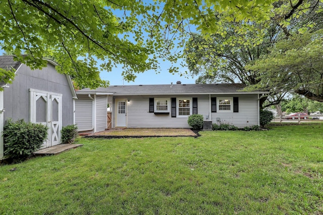 404 Stella Ave, Circleville, OH 43113 - back of property featuring a lawn and central AC unit