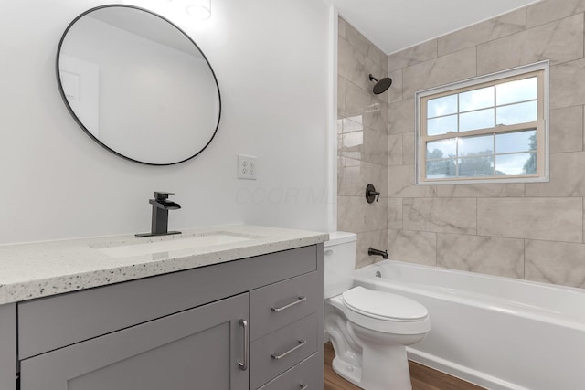 404 Stella Ave, Circleville, OH 43113 - bathroom with vanity, toilet, washtub / shower combination, and wood finished floors