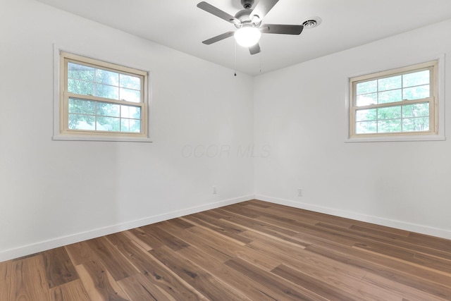 404 Stella Ave, Circleville, OH 43113 - spare room featuring healthy amount of natural light, baseboards, and dark wood-type flooring