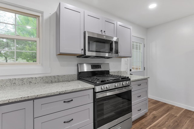 404 Stella Ave, Circleville, OH 43113 - kitchen featuring appliances with stainless steel finishes, dark wood-type flooring, light stone countertops, baseboards, and recessed lighting