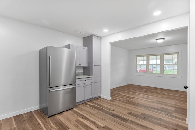 404 Stella Ave, Circleville, OH 43113 - kitchen with freestanding refrigerator, wood finished floors, baseboards, recessed lighting, and gray cabinets