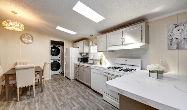 2011 Bluffstone Ct, Grove City, OH 43123 - kitchen with under cabinet range hood, stacked washer / drying machine, white appliances, and a textured ceiling