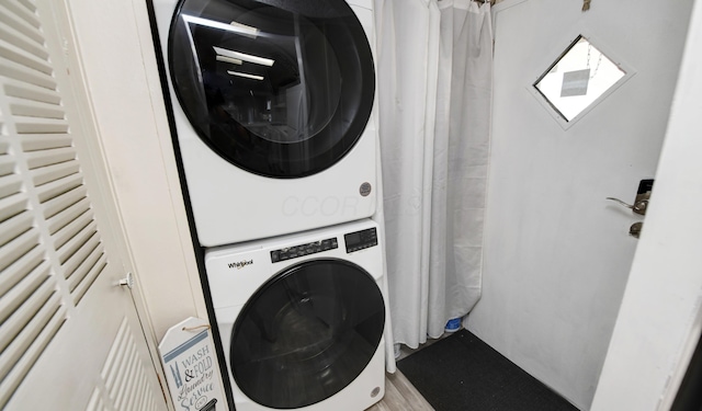 2011 Bluffstone Ct, Grove City, OH 43123 - clothes washing area with stacked washing maching and dryer, laundry area, and wood finished floors