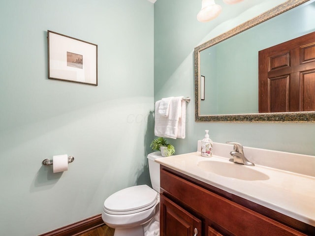half bathroom featuring toilet and vanity