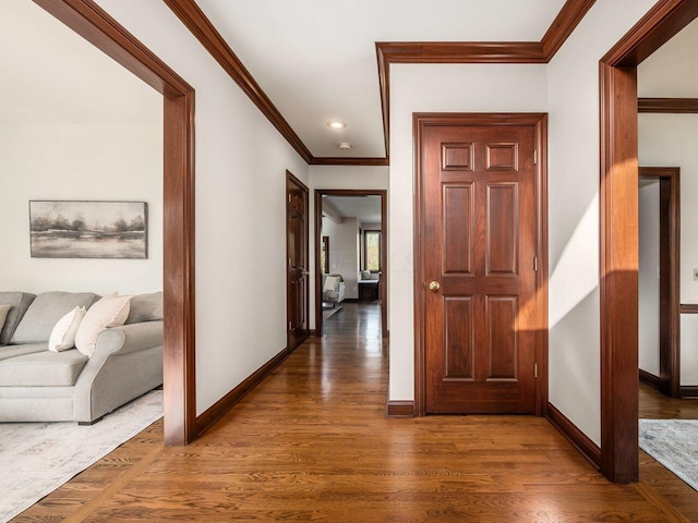 hall with crown molding, wood finished floors, baseboards, and recessed lighting