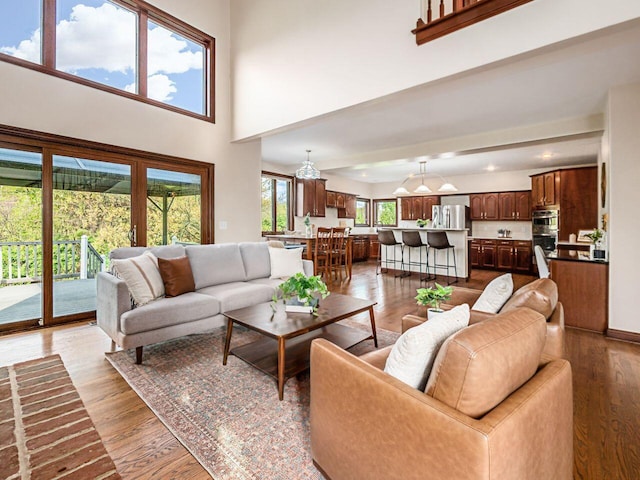 living area featuring wood finished floors and a towering ceiling