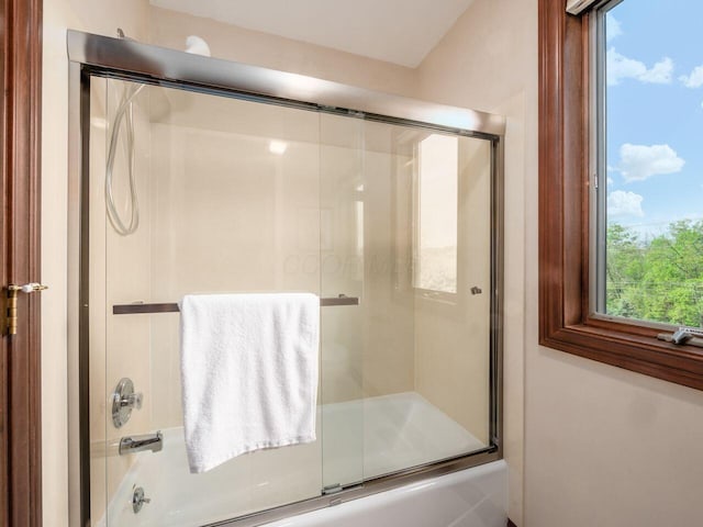 bathroom with shower / bath combination with glass door