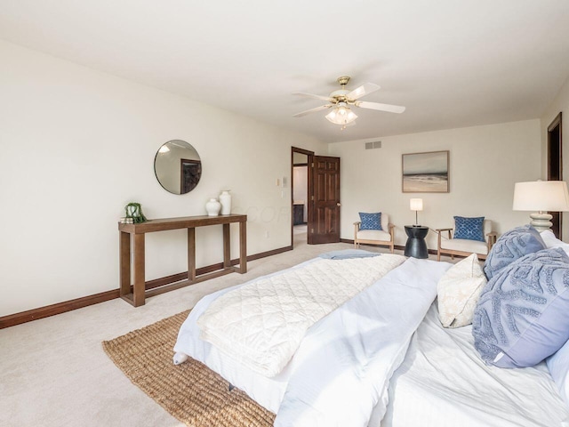 bedroom featuring light colored carpet, visible vents, baseboards, and ceiling fan