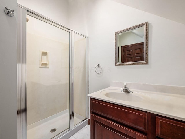 bathroom with a shower stall and vanity