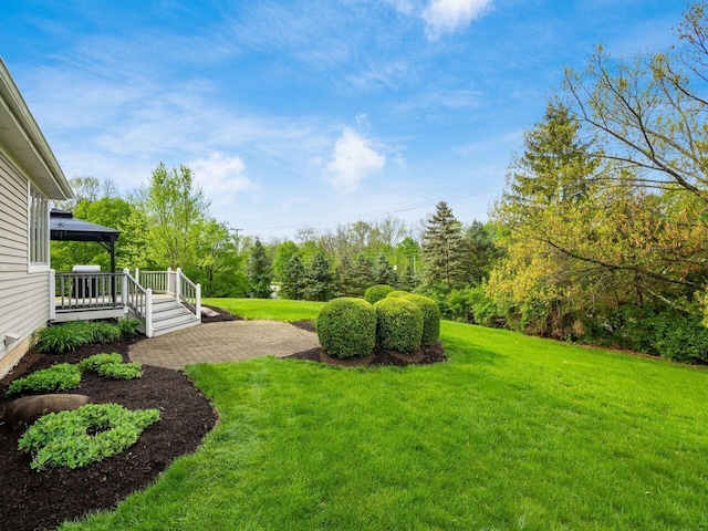 view of yard with a deck and a gazebo
