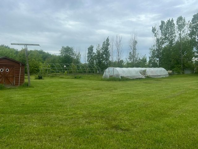 256 Mudswitch Rd, Martinsville, OH 45146 - view of grassy yard featuring an outbuilding, a greenhouse, and a storage shed