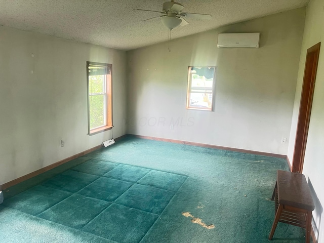 256 Mudswitch Rd, Martinsville, OH 45146 - carpeted spare room featuring a wall unit AC, a textured ceiling, a ceiling fan, and baseboards