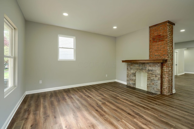 324 E Mound St, Circleville, OH 43113 - unfurnished living room featuring recessed lighting, baseboards, a stone fireplace, visible vents, and wood finished floors