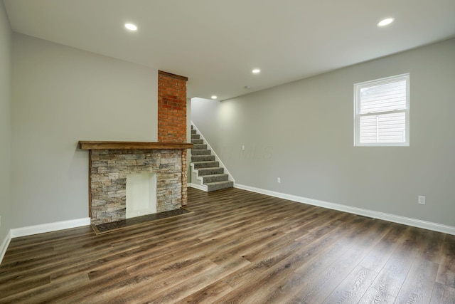 324 E Mound St, Circleville, OH 43113 - unfurnished living room with recessed lighting, baseboards, a stone fireplace, dark wood finished floors, and stairway