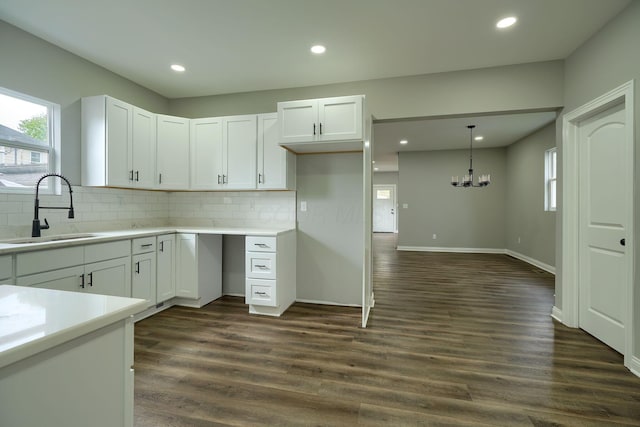 324 E Mound St, Circleville, OH 43113 - kitchen featuring a sink, backsplash, and white cabinets