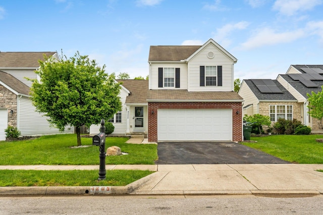 traditional-style house featuring driveway, brick siding, a front lawn, and a garage
