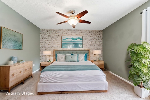 bedroom with an accent wall, ceiling fan, carpet, and baseboards
