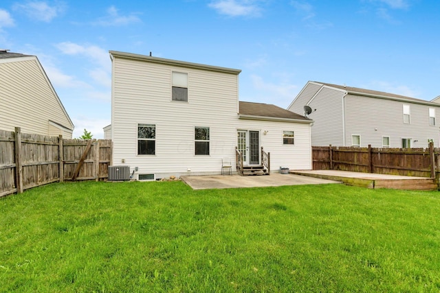 rear view of house with central AC unit, entry steps, a patio area, and a fenced backyard