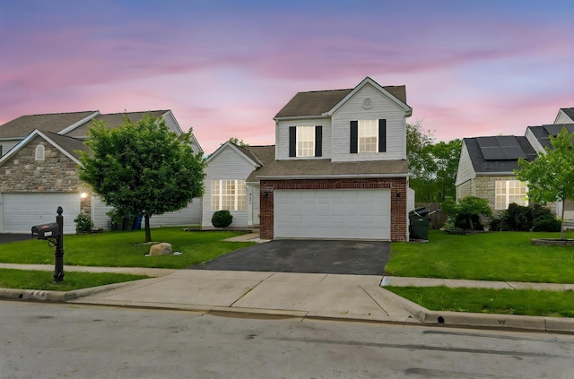 traditional-style home with driveway, brick siding, a front lawn, and a garage