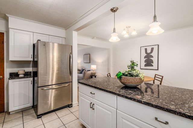 1775 NW Ct Unit 109, Columbus, OH 43212 - kitchen featuring freestanding refrigerator, ornamental molding, white cabinets, light tile patterned floors, and hanging light fixtures